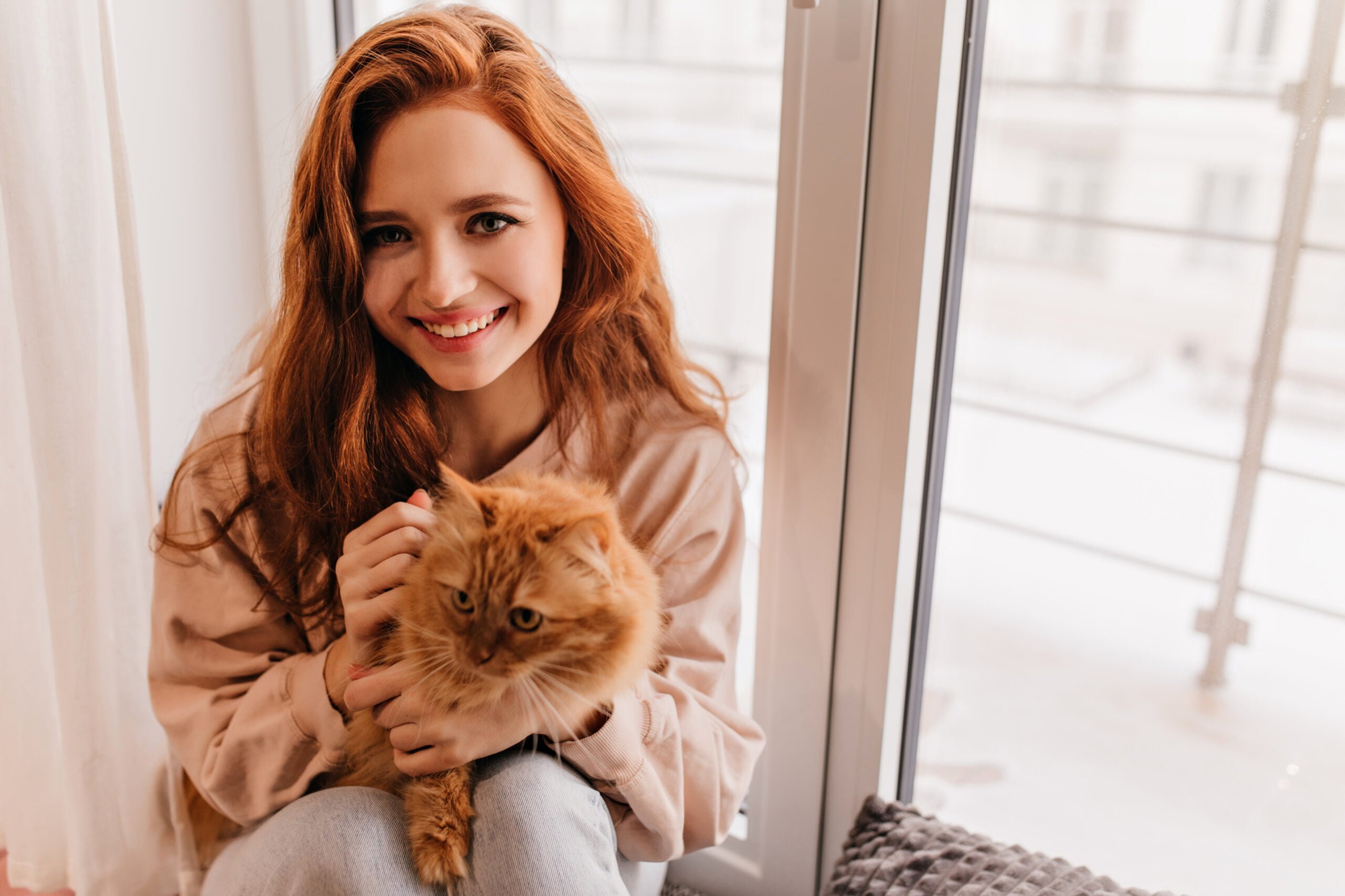 young-woman-with-cat-in-apartment young-woman-with-cat-in-apartment
