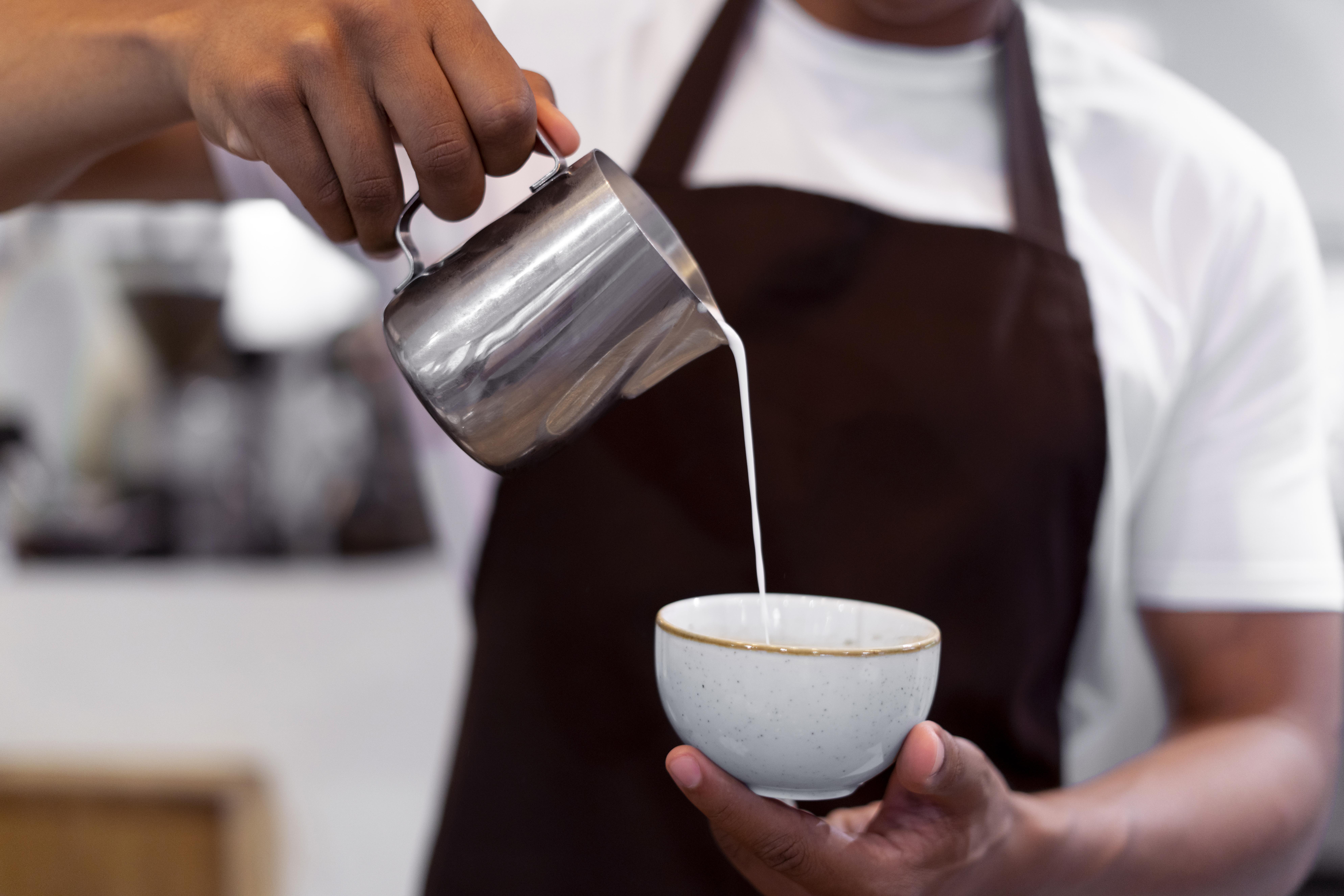 Close up of barista making coffee at one of the best coffee shops near malta, ny