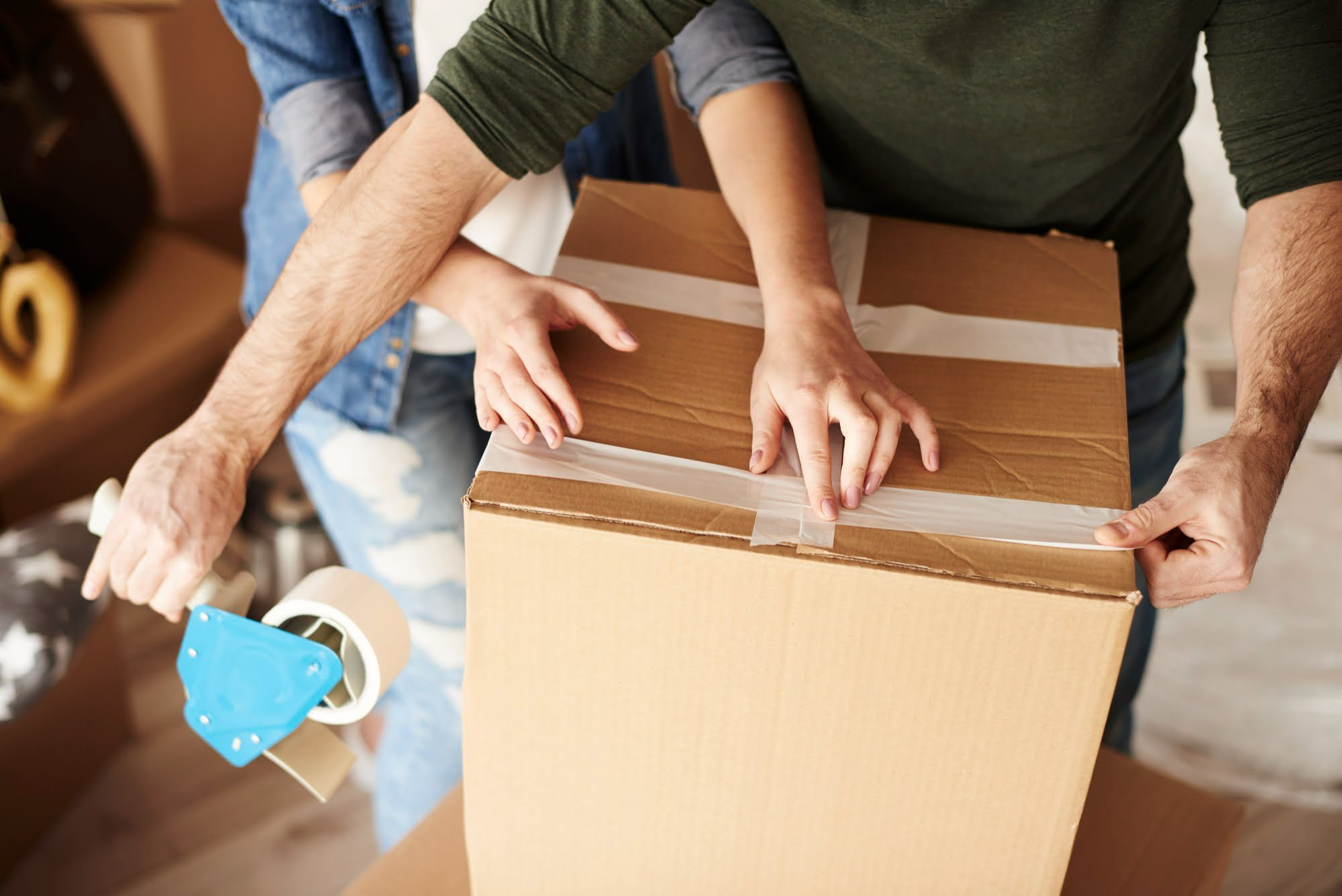 young couple packing and moving to new apartment
