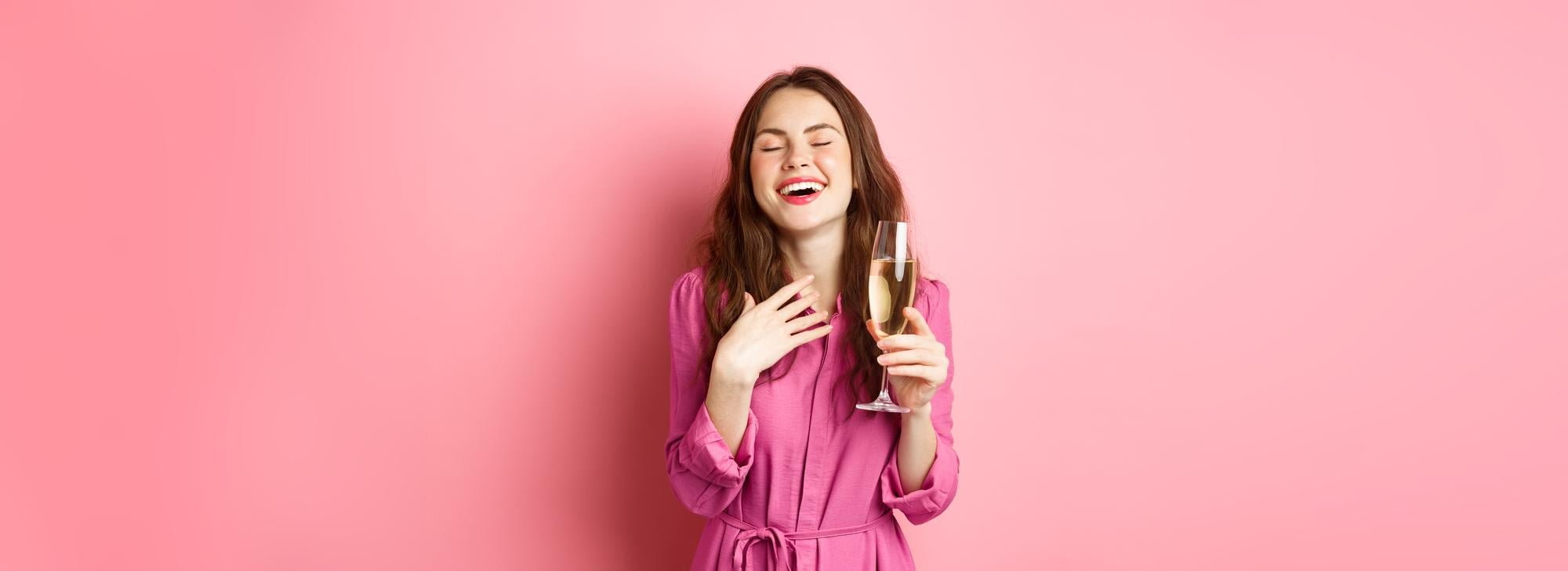 young-woman-in-sparkle-dress-holding-wine-glass-while-throwing-a-Galentines-Day-Party-at-your-apartment