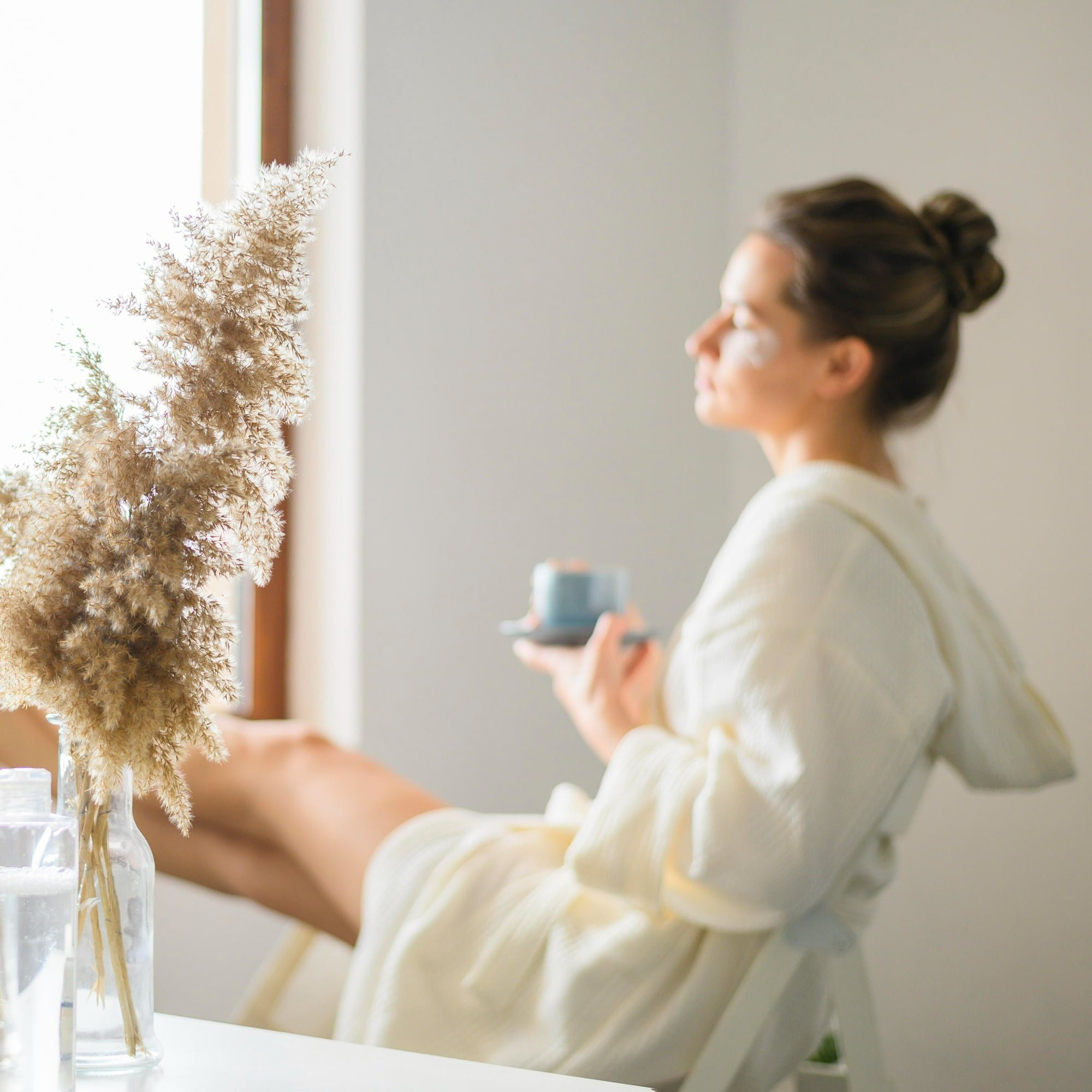 woman enjoying tea and at home spa day practicing self-care from your apartment